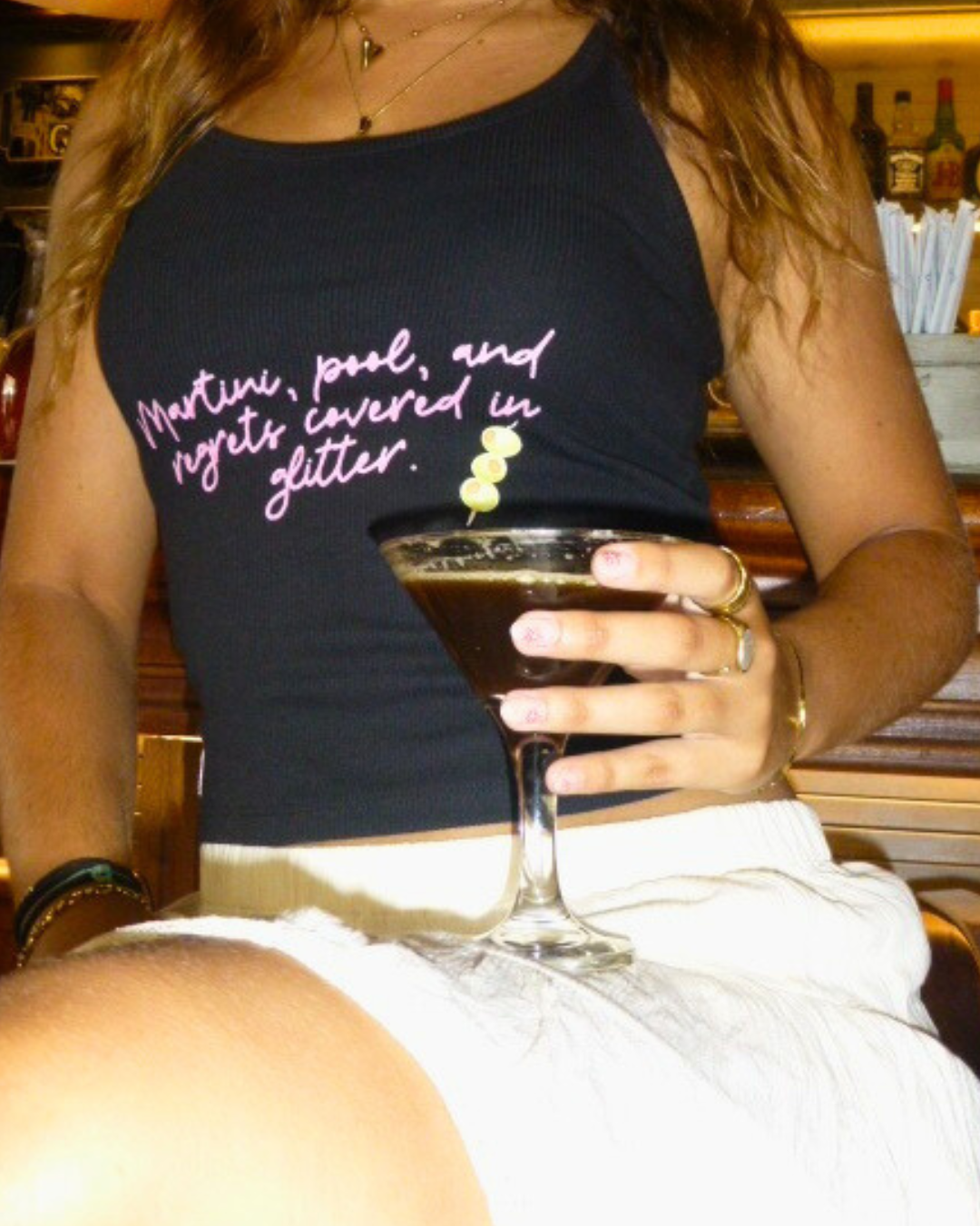 "Martini, pool, and regrets covered in glitter."